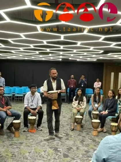 Our facilitator Aman leading a session in a uniquely designed office space. The message is simple: we are all connected. A drum circle makes that connection audible and tangible.