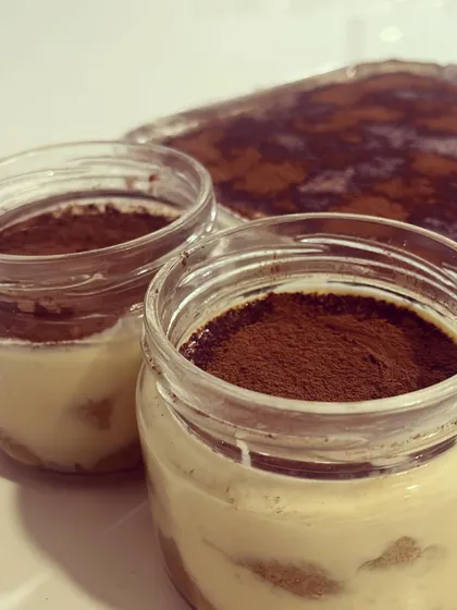 A close-up of my Baileys Irish Cream Tiramisu, available in individual jars or a larger tray for sharing. It's a rich and creamy dessert that I make fresh for my catering events.