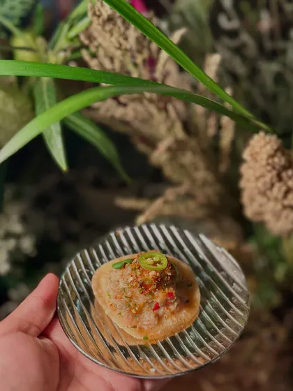 A modern take on a classic Indian street food, this appetizer features a crispy base topped with a flavourful mixture.