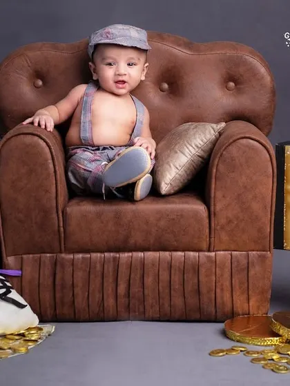 I'm the boss! This little guy means business, sitting in his leather armchair with his laptop and bags of money.