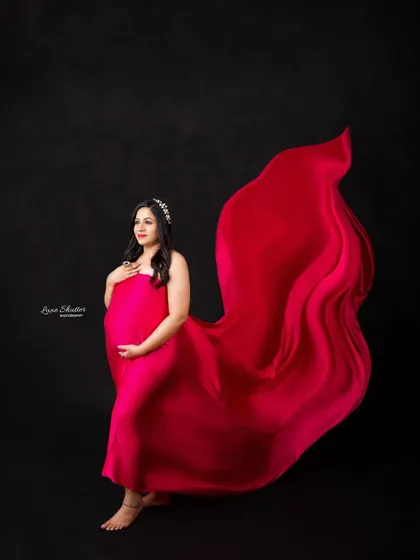 Another powerful fabric toss, showcasing the versatility of this pink gown. It can be styled for soft, romantic looks or bold, dynamic portraits.