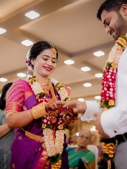 The ring exchange. A close-up of the groom placing the ring on the bride's finger, a pivotal moment in their engagement ceremony.