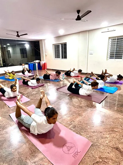 Another view of our students in Bow Pose, showcasing their dedication and strength. The synchronized movement creates a beautiful sense of unity in the class.