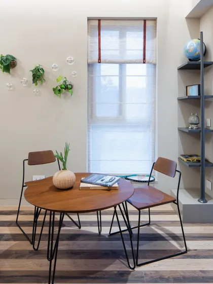 A cozy corner workspace with striped wooden flooring, demonstrating how work areas can be naturally integrated into home living.