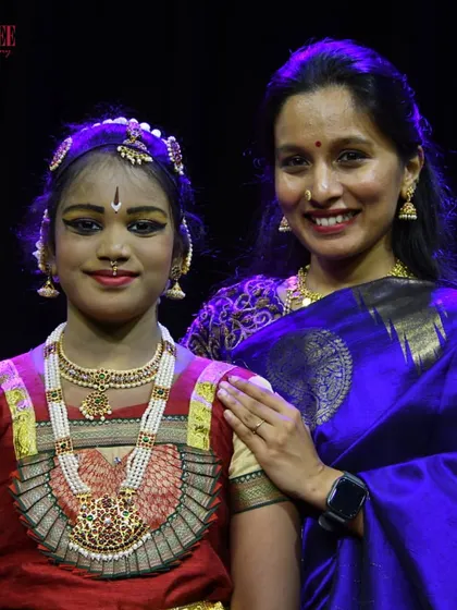 A proud moment between a teacher and student at our Nritya Sanje event. We believe in nurturing each dancer's individual journey and celebrating their milestones together.