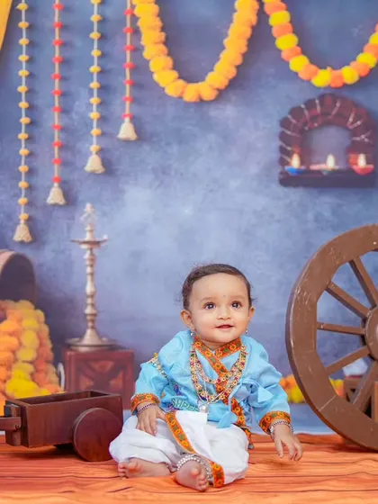 This shot showcases the full, colorful backdrop and the baby's adorable expression. Themed shoots are a fantastic way to celebrate important milestones and create unique photographs.
