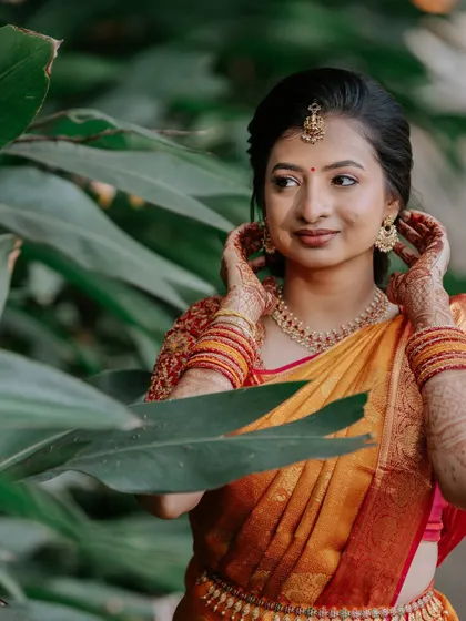 A close-up showcasing the delicate details of her bridal look. The makeup is soft and glowing, designed to enhance her features and harmonize with her intricate jewellery.