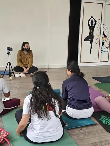 A theory session in our TTC. Our guru sits with a small group of students, discussing the philosophy and principles of yoga, bridging the gap between practice and knowledge.
