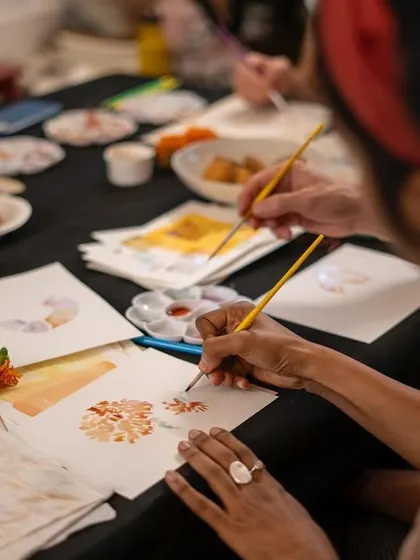 This is the heart of our botanical ink workshop. A participant carefully paints with colors they helped create, extracted directly from flowers and natural materials. It’s a magical process of turning nature into art, one brushstroke at a time.