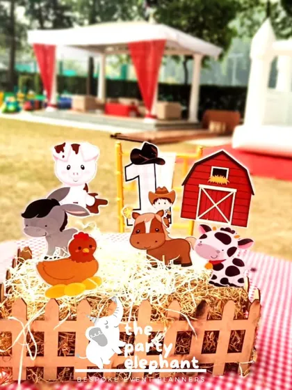 Themed centerpieces tie the whole party together. For the barnyard party, I created these adorable table decorations using hay, a miniature fence, and cutouts of favorite farm animals.