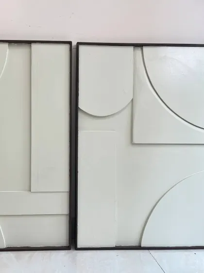 A straight-on view of the white minimalist diptych. The composition is abstract and geometric, designed to create a sense of calm and order.