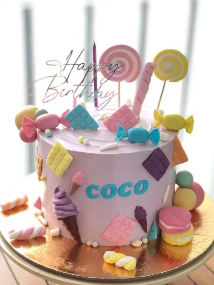 A pastel Candyland cake, perfect for a sweet-themed birthday party.