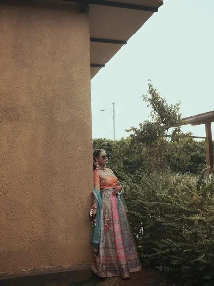 A wide, atmospheric shot of the bride during her Haldi day, capturing the mood and setting.