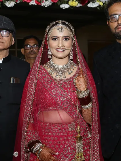 A lovely shot of the bride making her entrance, surrounded by her family.