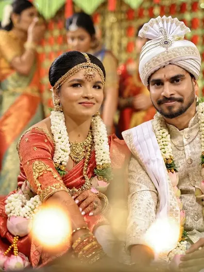 The couple seated by the sacred fire during their Hindu wedding ceremony, a classic shot capturing the essence of the rituals.
