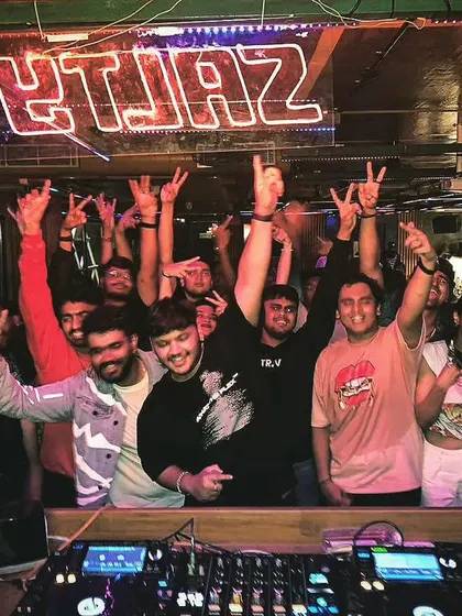 A group photo with the entire crew and a packed crowd at a club in Hyderabad. It's a core memory from a fantastic night.