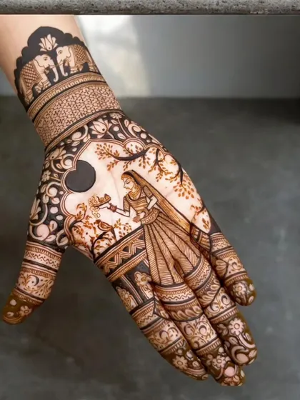A single hand adorned with a beautiful portrait of a bride. The surrounding patterns are traditional, with elephants and fine details, making it a perfect bridal design.