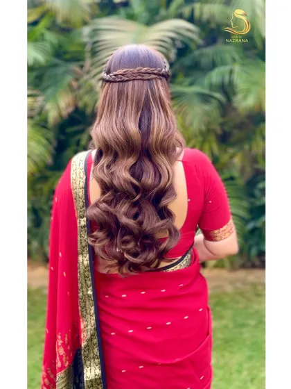 The back view of the braided crown, showing the neat fishtail braids and voluminous waves.