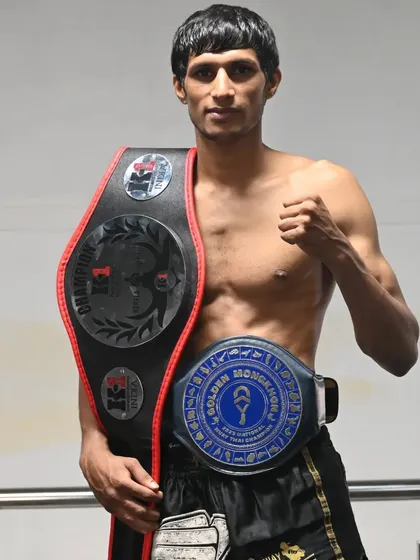 A portrait of a champion. Sumanth with his hard-earned title belts, a symbol of his dedication to the sport.