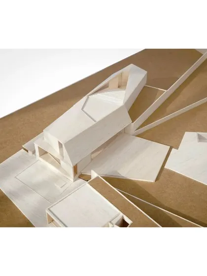 A detail of the Lakehouse model, highlighting the interlocking volumes and the way the building straddles the line between the enclosed forecourt and the open lakeside.