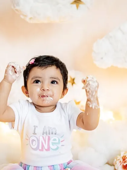 This little one is proud to be one and isn't afraid to get messy. The "I am ONE" shirt and a face full of frosting make for the perfect cake smash photo.