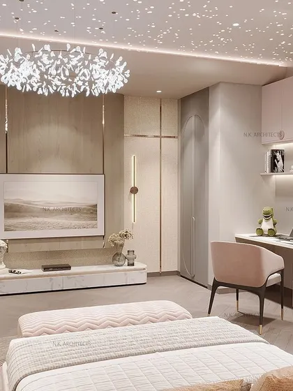 The TV and study area in the pink and grey room. The design is cohesive, with custom furniture and shelving that match the room's elegant and modern aesthetic.