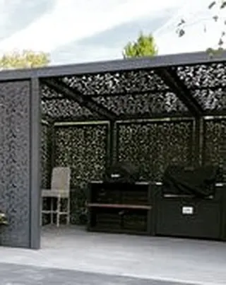 A custom-designed pergola with laser-cut decorative panels for the roof and walls. This unique structure provides dappled shade and creates intricate light patterns, serving as a functional art piece.