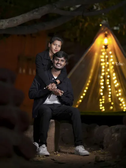 A romantic embrace in a softly lit tent. The lighting creates a beautiful, gentle mood for this pre-wedding night shoot.