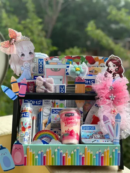 This stationery hamper is a dream for any young artist, especially with its cute princess theme. It's filled with Doms art supplies, cotton candy, and adorable hair accessories, making it a perfect birthday or return gift.