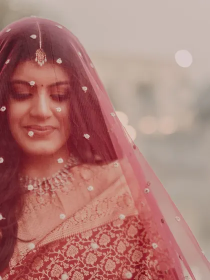 A serene and beautiful portrait of the bride under her veil, her eyes closed. This shot is full of grace and quiet emotion.