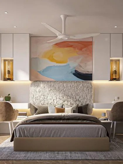 A bright and airy bedroom that feels like a luxury hotel suite. The design includes two separate desk spaces flanking the bed, a vibrant piece of abstract art, and a stunning textured headboard for a touch of glamour.