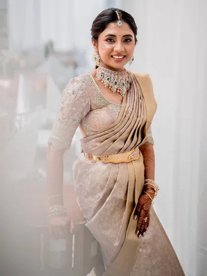 Monisha looking elegant and poised in her gold and beige ensemble. The custom-embroidered blouse perfectly complements her saree and diamond jewelry, creating a look of understated luxury.