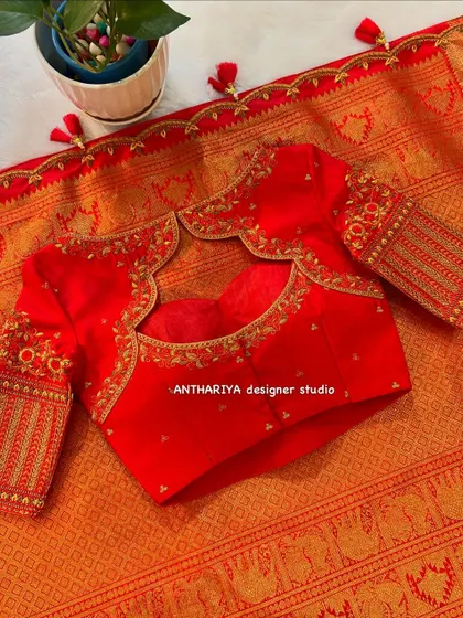 A beautiful red blouse with a stylish back cutout and delicate embroidery.
