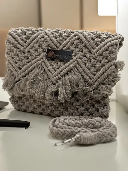 A chic and simple grey sling bag with a chevron pattern and delicate fringe. It's perfect for everyday wear.
