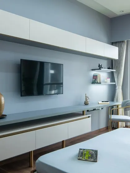 This bedroom at SNN Clermont combines stillness and structure. The grid-style wall paneling and floating TV unit create a clean, organized look, while the view from the balcony adds a sense of openness.
