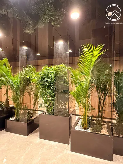 The interplay of light, reflection, and greenery in this corridor at the Hyderabad office. Our designs are planned to interact with the architectural elements of a space, creating dynamic and evolving visual experiences.