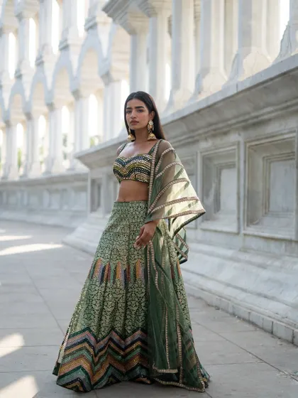 Creating picture-perfect moments in our green multi-patterned lehenga. A beautiful choice for any wedding guest.