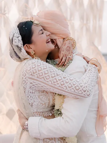 A heartfelt hug. The emotion in this photograph is palpable, showcasing the deep bond between the couple.