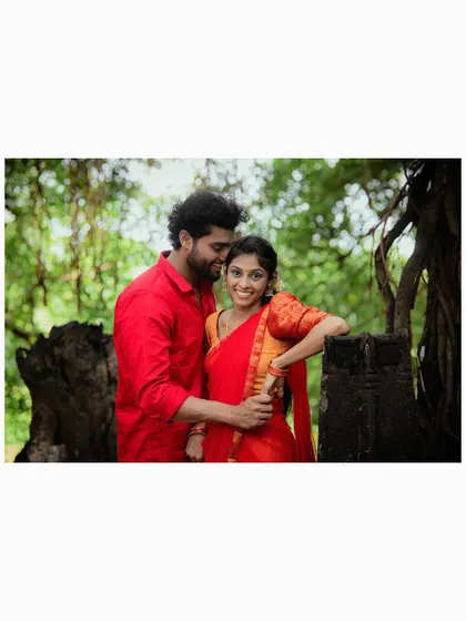 A warm and intimate portrait of a couple in a rustic, natural setting.