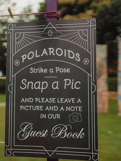 A polaroid guest book station, encouraging guests to snap a photo and leave a personal note for the couple.