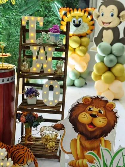 More details from Avyaan's party, showing a decorative ladder with the letters 'TWO' and various animal figures, adding height and interest to the overall setup.
