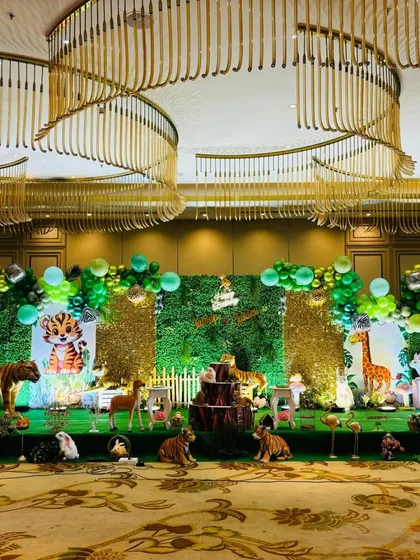 Another angle of the large-scale jungle party decor, featuring a light-up marquee number "3" and various animal figures.