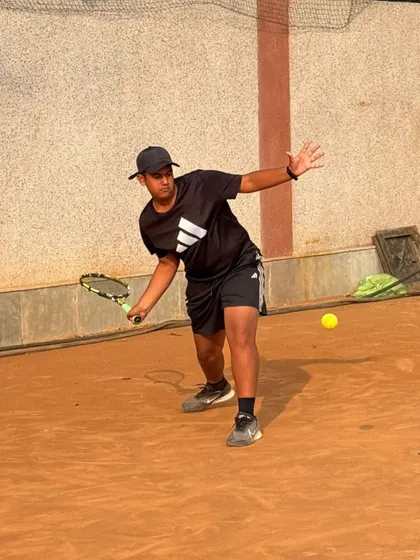 A player practicing his slice backhand. We teach a variety of shots to give our players a complete, all-court game.