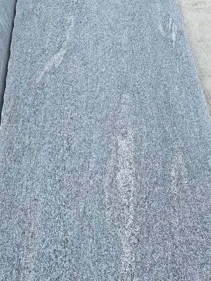 A close-up detail of a flamed granite slab, showing the textured surface that provides excellent grip.