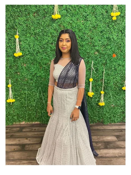 The bride's sister looking radiant in a glitter fish-cut lehenga with an attached dupatta. This outfit was part of a coordinated set I created for her and her partner.