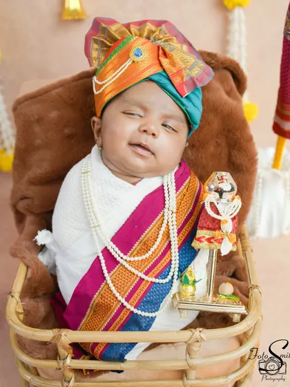 A sleepy newborn celebrating his first Gudi Padwa. The traditional pheta (turban) and shawl make for an incredibly cute and memorable first festival portrait.