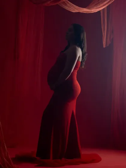 Another silhouette from the red-themed shoot, capturing a different angle and playing with light and shadow.