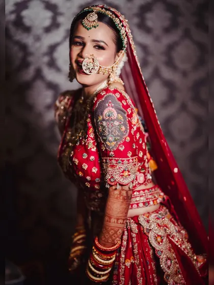 A playful and happy bride. Her complete look, from the makeup to the perfectly draped dupatta, is designed to let her personality shine.