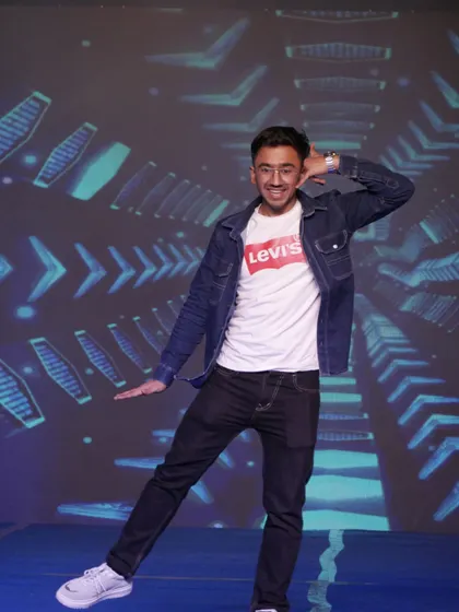 A student performer strikes a pose during a high-energy dance number at our annual show.