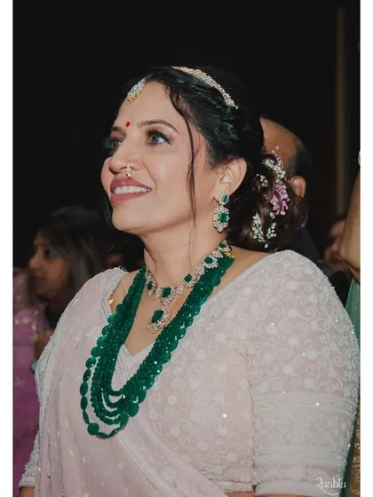 The mother of the bride looking timelessly elegant. I created a classic look with a defined eye and a soft lip color to complement her beautiful saree and emerald jewelry.
